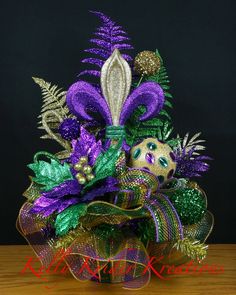 a close up of a purple and green flower arrangement