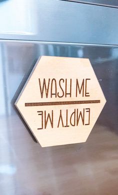 a wooden sign that says wash me, endia we on the side of a refrigerator