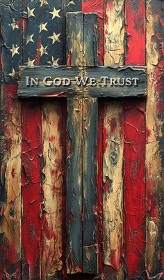 an american flag painted on the side of a building with a sign that says in god we trust