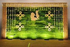 a stage set up with green and gold decorations