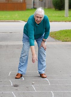 Image of a women preventing decreased mobility of the spine by stretching. Lower Back, Stretching, Parachute Pants, Normcore, Pants, Trousers