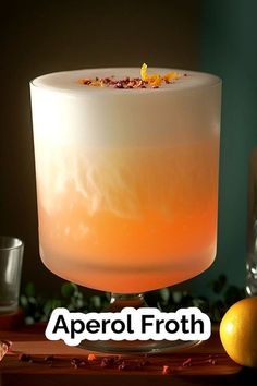 an orange and white drink sitting on top of a wooden table