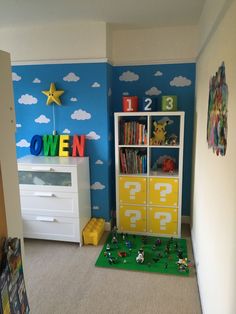 a child's bedroom decorated in blue, yellow and white with toys on the floor