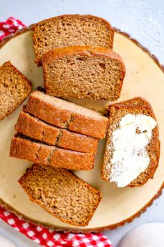 slices of bread on a plate with cream cheese in the middle and red checkered napkin