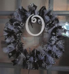 a black and white wreath on the front door