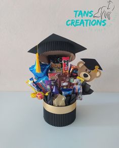 a graduation hat with candy, candies and other items in it sitting on a table