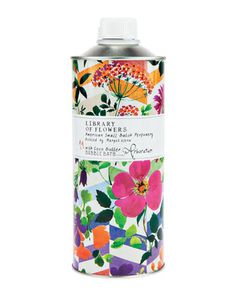 an image of a canister with flowers and leaves on the side, in front of a white background