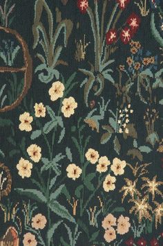 an image of a tapestry with flowers and plants on it's side, in the dark