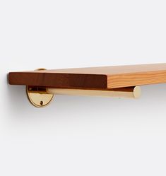 a wooden shelf mounted to the side of a wall