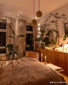 a bedroom decorated with plants and candles