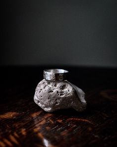 a rock ring sitting on top of a wooden table