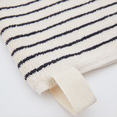 a black and white striped rug with a ribbon on it