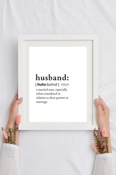 two hands holding up a framed print with the words husband