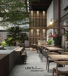 an empty restaurant with tables and chairs in front of the counter, surrounded by potted plants