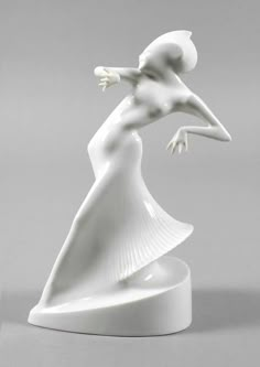 a white figurine with a woman's head in the air