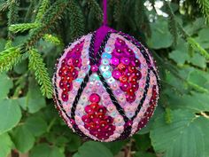 a colorful ornament hanging from a tree