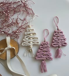 crocheted ornaments are displayed on a table with ribbons and other items around them