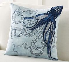 an octopus pillow sitting on top of a white couch