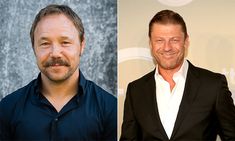 two men in black suits and one is smiling at the camera, both with beards