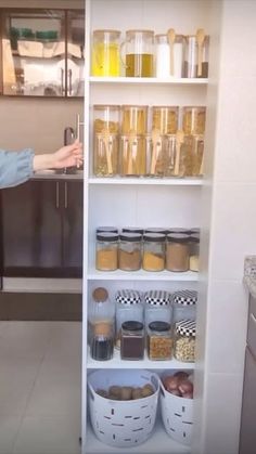 a woman standing in front of a pantry filled with food