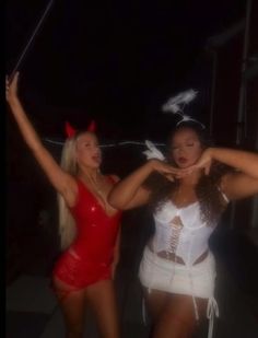 two women dressed in red and white posing for the camera with one holding her arm out