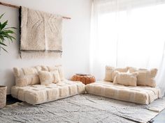 a living room filled with furniture and a rug on top of a carpeted floor