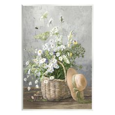 a painting of flowers in a wicker basket with a hat on the table next to it