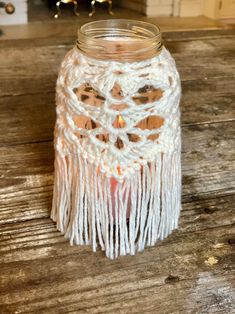 a glass jar with some white yarn on it