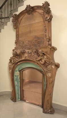 an ornate wooden fireplace in a room