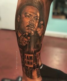 a man's leg with a portrait of martin luther king and words on it