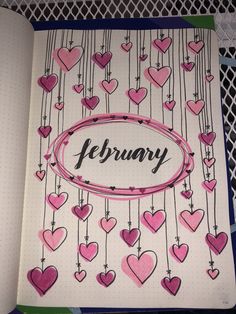 an open notebook with hearts and the word february written in cursive writing on it