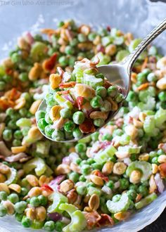 a spoon full of salad with peas and nuts