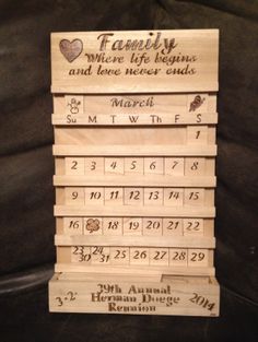 four wooden calendars stacked on top of each other, with names and dates printed on them