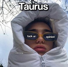 a woman wearing sunglasses with the words taurus written on her face and behind her head