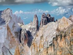 the mountains are covered in snow and clouds