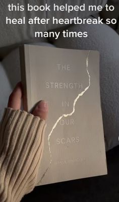 a person holding up a book with the words, this book helped me to heal after heart break so many times