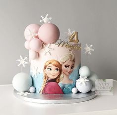 a frozen princess themed birthday cake with balloons