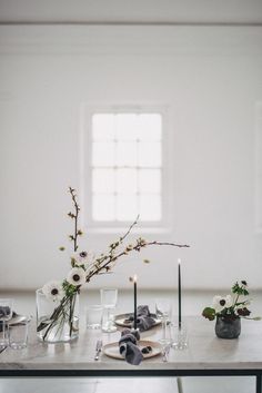 the table is set with flowers and candles