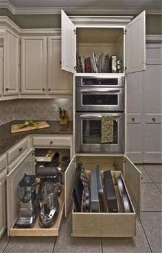 an open drawer in the middle of a kitchen