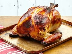 a whole chicken sitting on top of a wooden cutting board