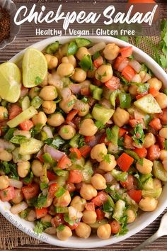 chickpea salad in a white bowl with cilantro and lime