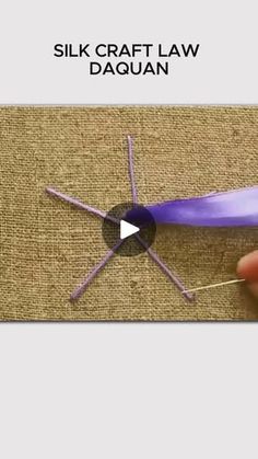 a video demonstrating how to make a silk craft law daquan with purple yarn