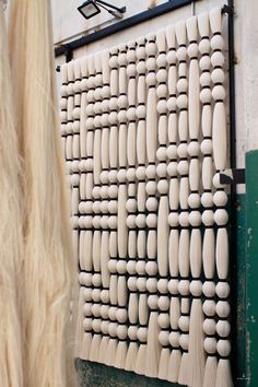 an art piece made out of wood and white paint on the side of a building