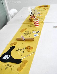 a long table with yellow paper on it and some stickers in the middle that have been cut out