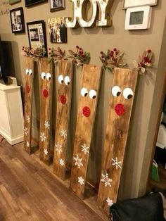 christmas decorations made out of wooden planks with reindeer noses and snowflakes on them