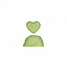 two slices of cucumber in the shape of a heart on a white background