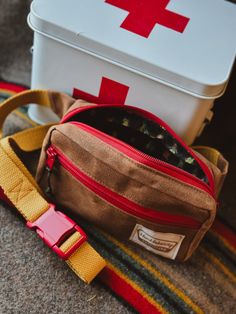 THE CAMP COLLECTION Oak brown waxed canvas exterior, featuring forest green beetles on the interior.  The Routt Fanny Pack is the perfect blend of function and fashion! Easy to wear as a traditional fanny pack/bum bag, or lengthen the adjustable strap wear it crossbody! Roomy enough for the essentials, and easy to keep on under a coat or in the car, this bag screams cute and convenient. Beautiful 1" mustard yellow cotton webbing paired with a striking and sturdy plastic red buckle. Strap length Belt Bag Leather, Green Beetle