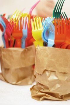 plastic forks and spoons in a brown paper bag