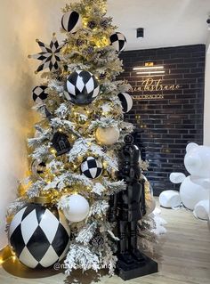 a decorated christmas tree with black and white ornaments