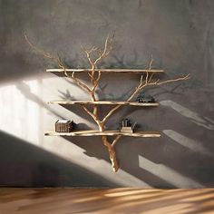 there is a tree shelf with books on it in the middle of a room that appears to be made out of wood